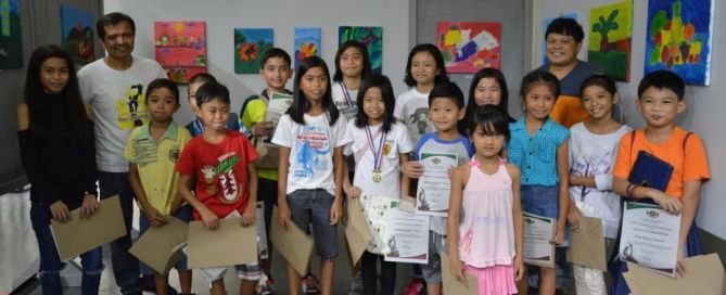 A photo of kids with their artworks
