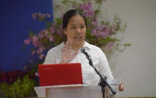 Asst. Prof. Cha Reyes, master of the ceremony and one of the presenters, in the morning forum.