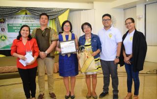 Presentation of certificate and token to Dr. Serrano