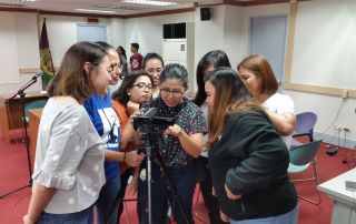 Participants studying the HD Camera during the hands-on session.