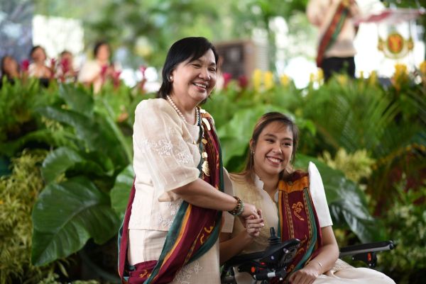 Joanne Laurice Caguicla (seated) with Dr. Melinda dela Peña Bandalaria, UPOU Chancellor.