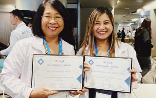 Prof. Consuelo Habito (left) and Asst. Prof. Mari Anjeli Crisanto (right) holding their certificates of completion of the 12th Assessor Training Workshop for AUN-QA Programme Assessment (Tier 2 Training)