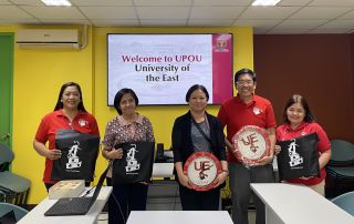 Dr. Myra C. Almodiel (center), Director of the UPOU Office of Public Affairs, with the visitors from the University of the East.