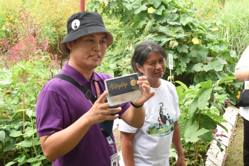 Dr. Jabez (left) and Ms. Reondanga (right) showing the significance of Alitaptap Community Currency in Perma G.A.R.D.E.N production during the orientation with Project LAKBAY fellows
