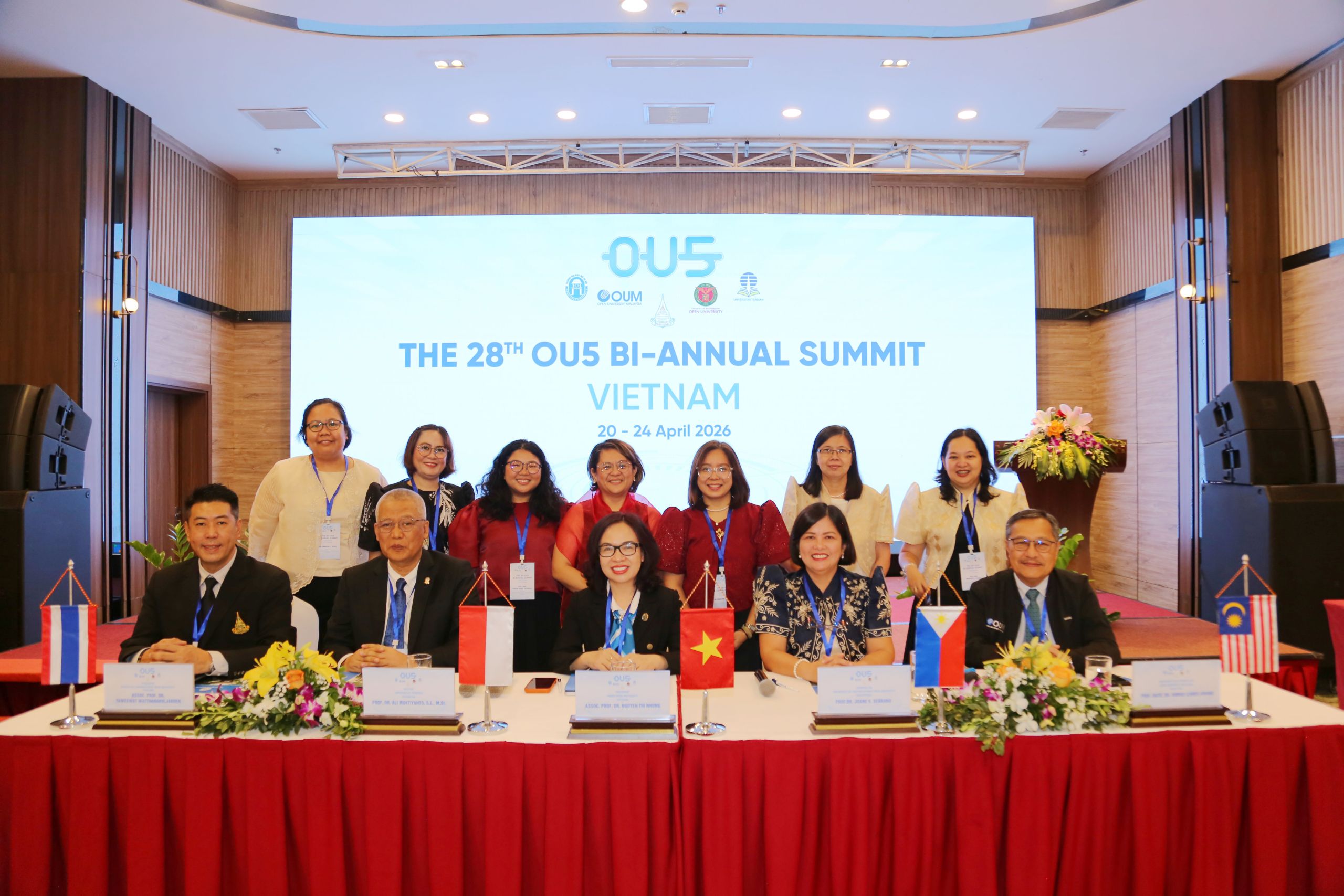 UPOU delegates (standing) with the leader of OU5 member agencies (seated).