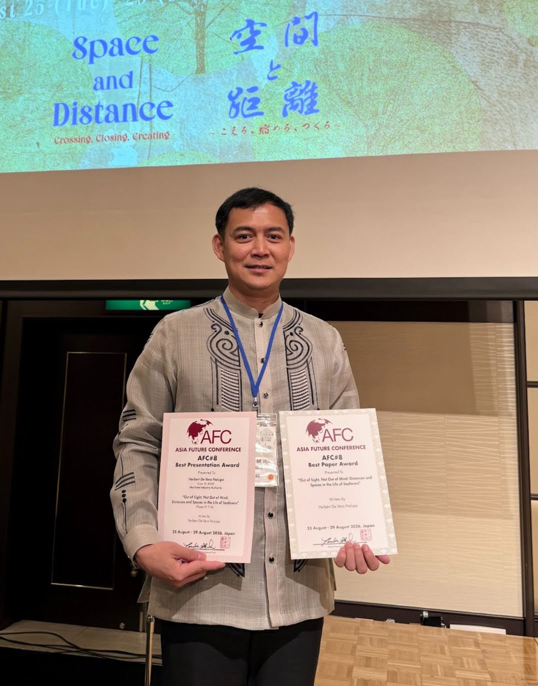 UPOU DSus student Herbert Nalupa with the two awards he received at the 8th Asia Future Conference in Japan.